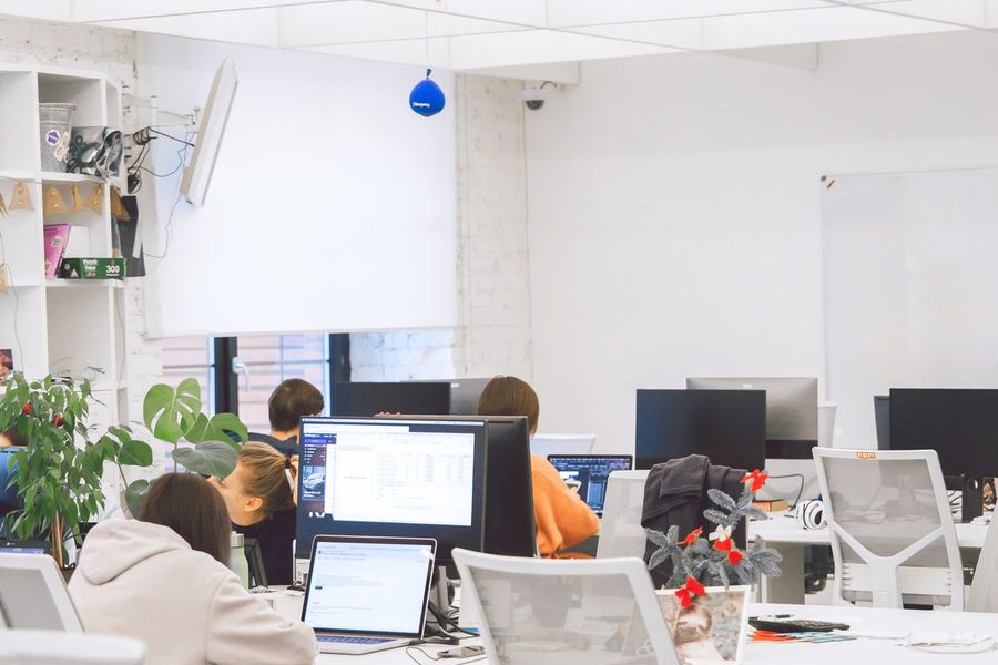 An open-plan office with staff at their workstations