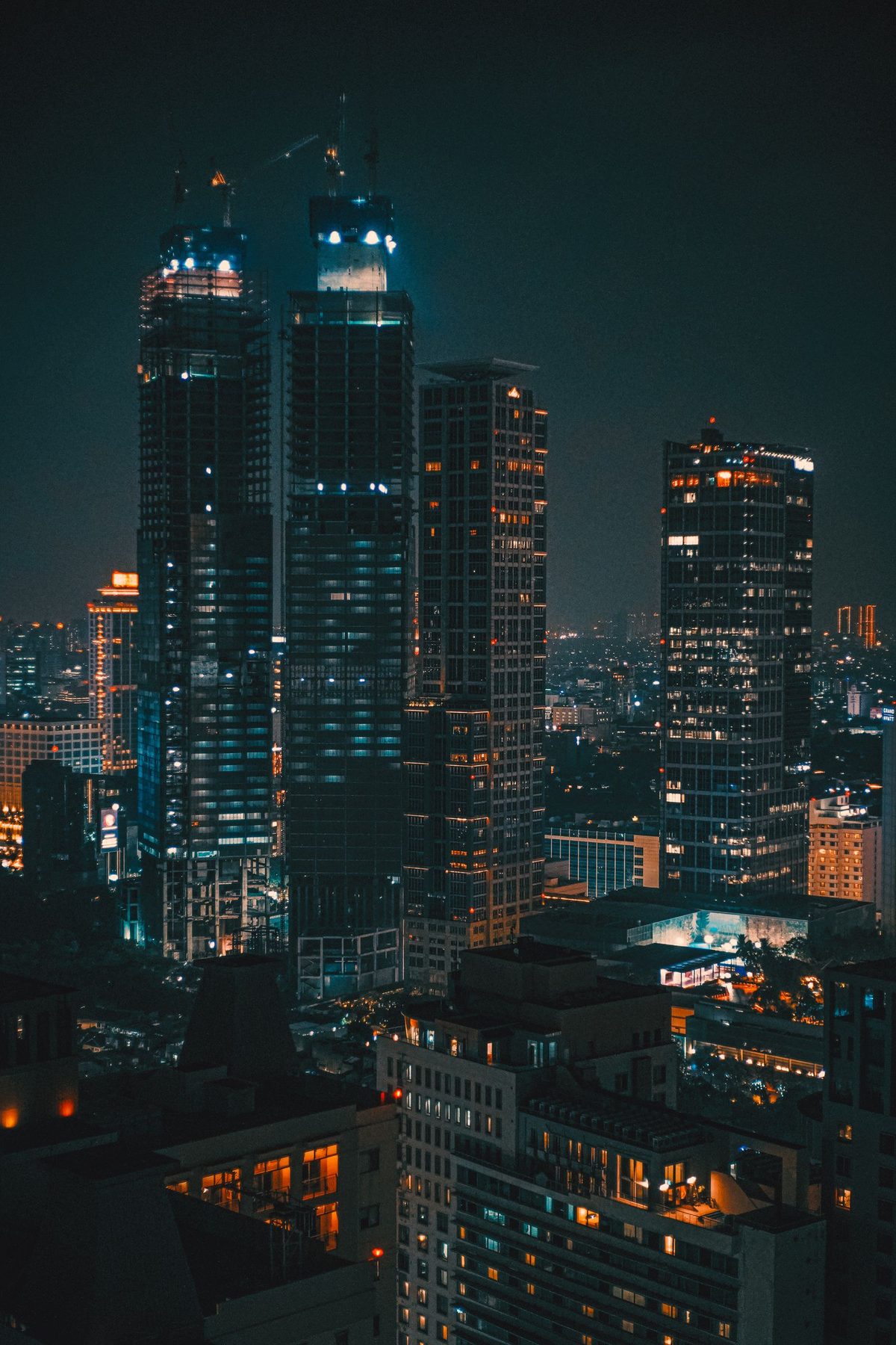 The Jakarta skyline at night, office towers still lit